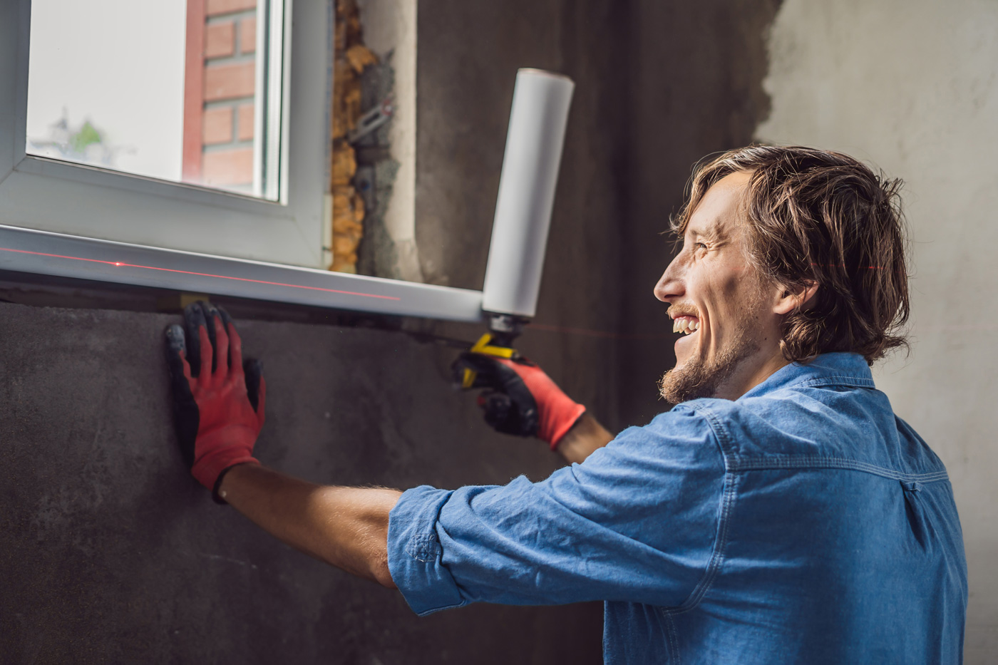 Male with a site improvement bond working on a building
