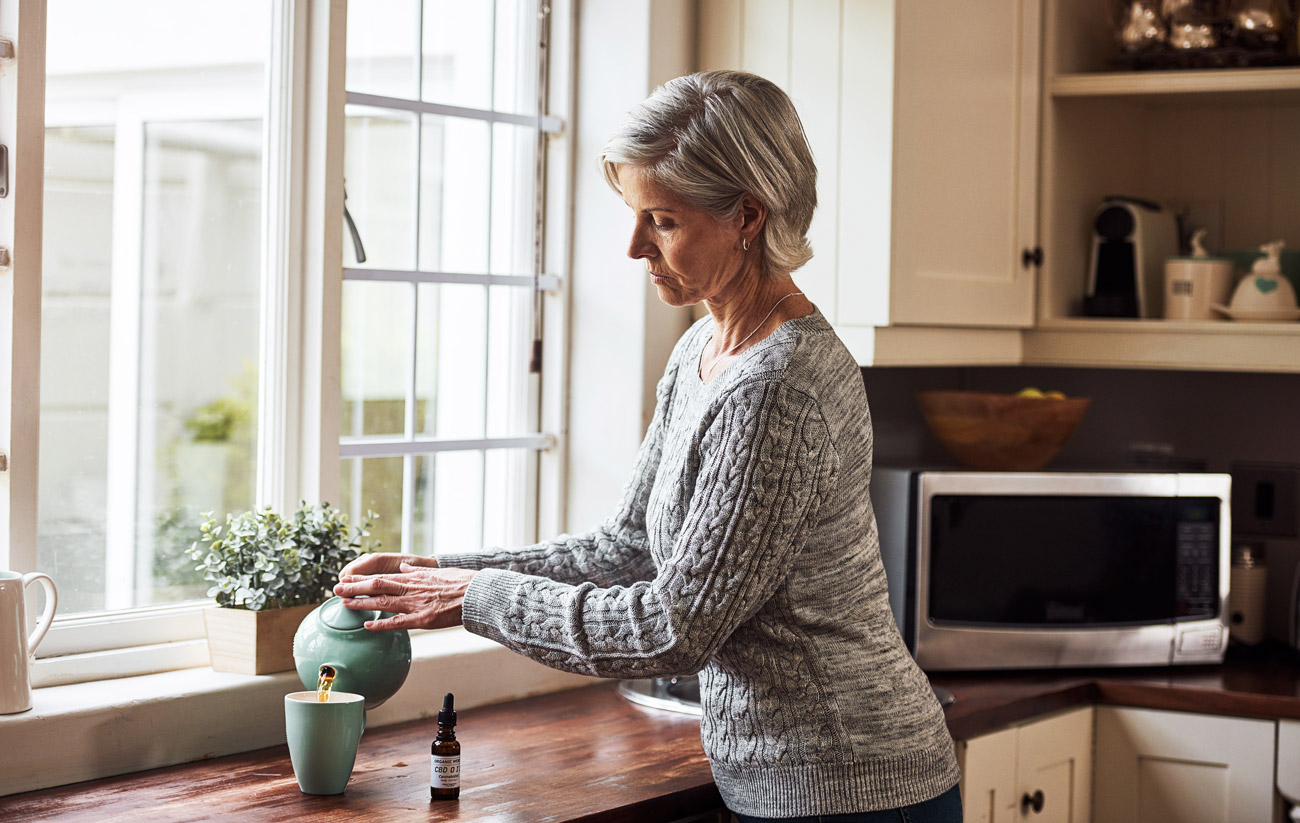 Woman in Maine using CBD oil from a bonded dispensary