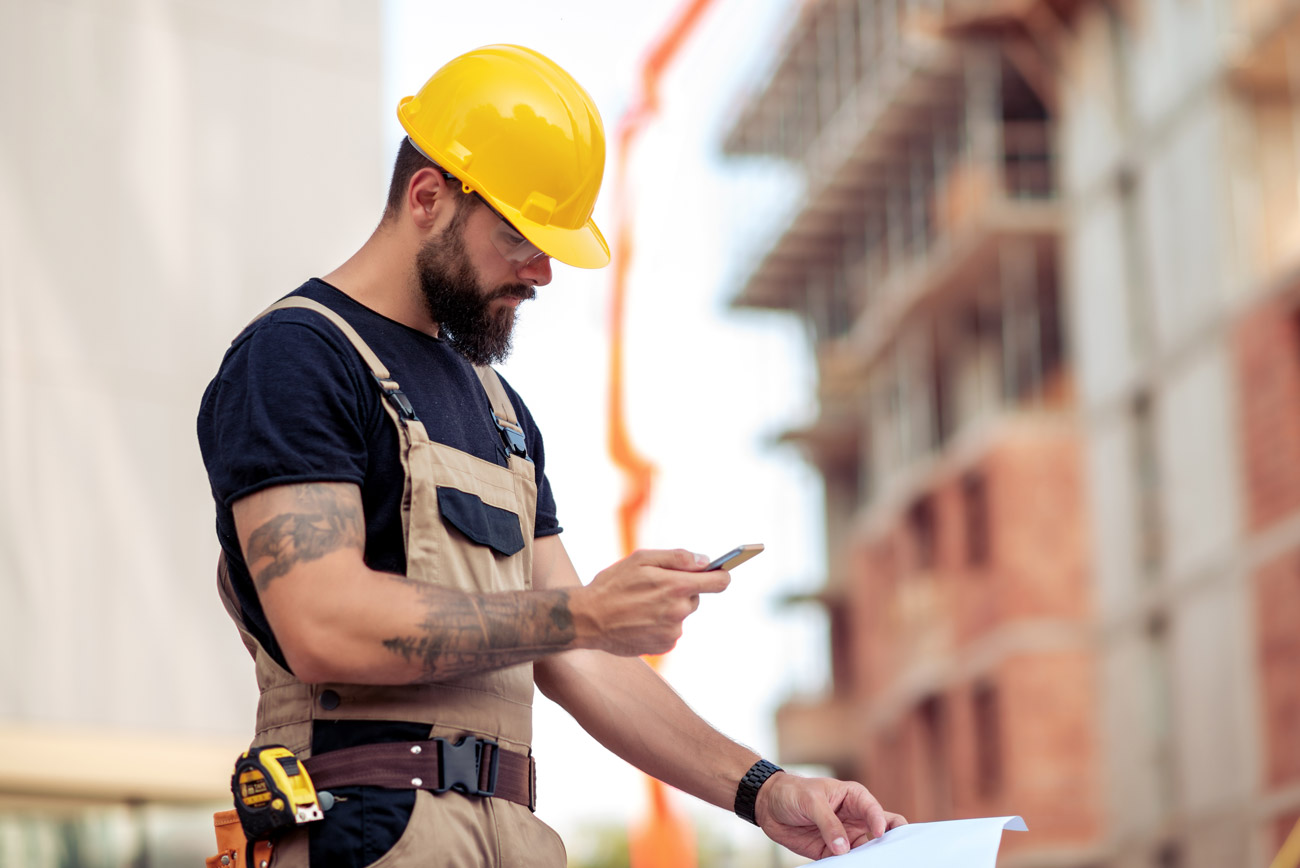 Bonded contractor looking at his phone in Rock Island