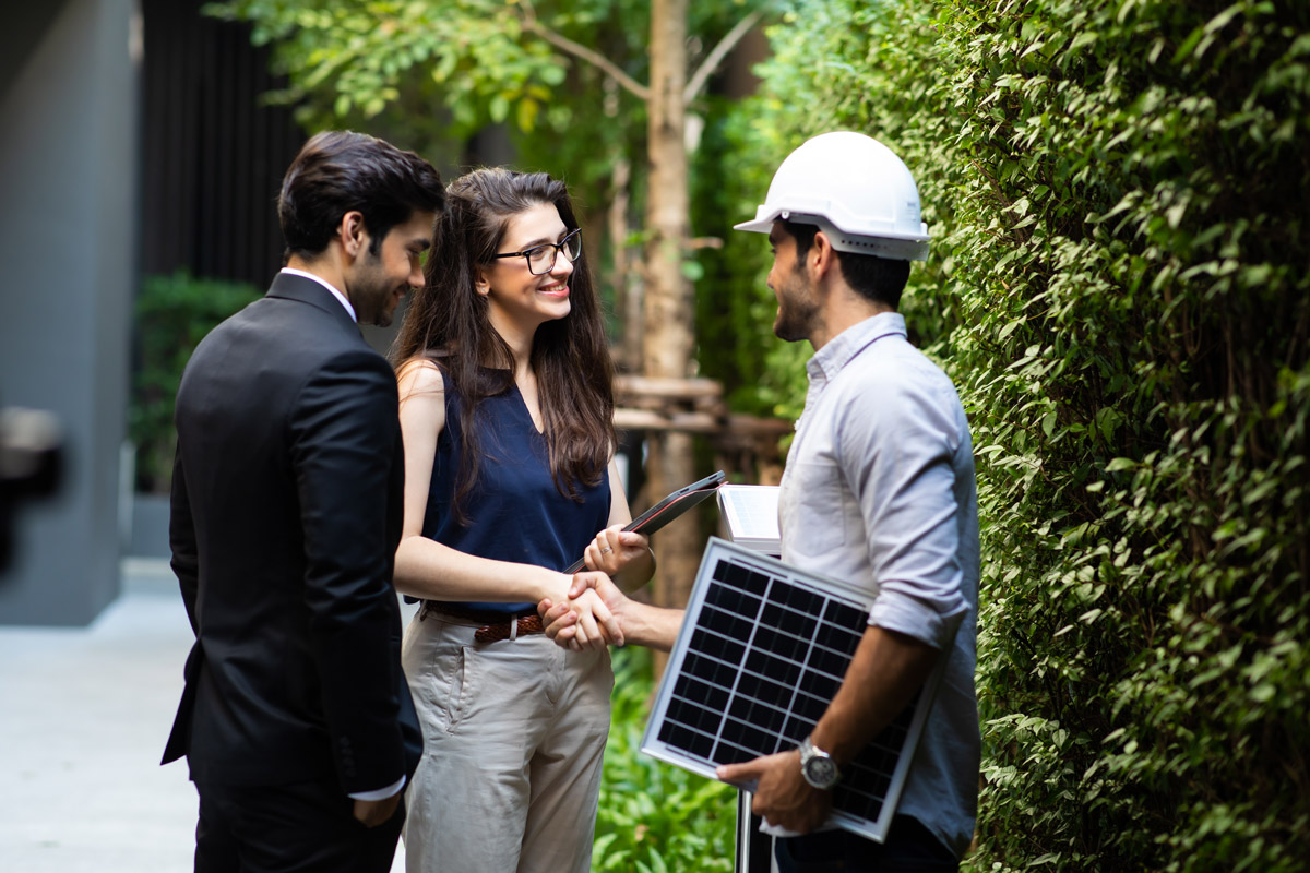 Couple shaking hands with an electrical contractor carrying a business services bond