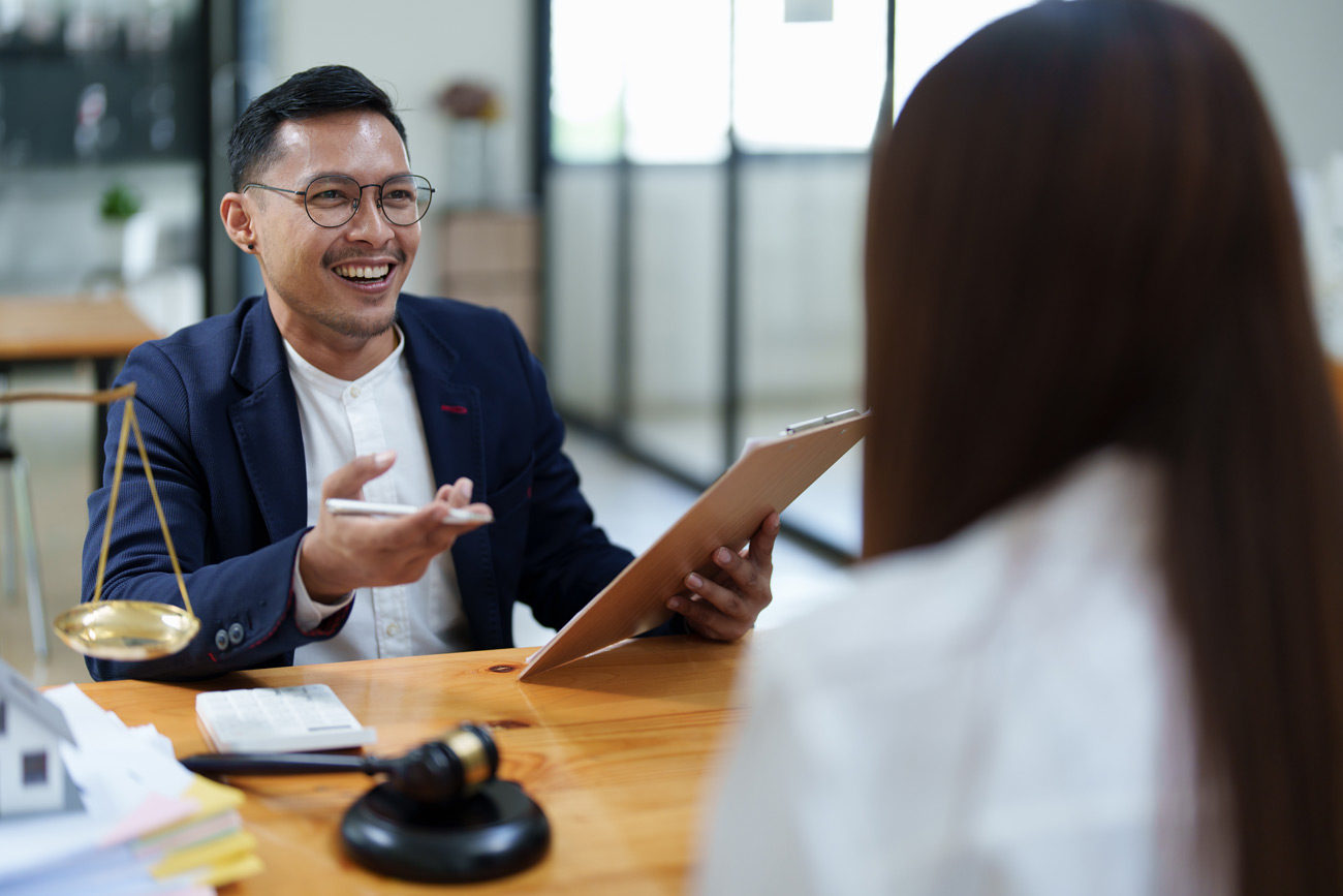 Smiling lawyer working with a defendant holding a release attachment bond